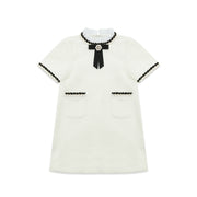 Girls' white tweed dress with black bow, cotton-lined, ideal for weddings or birthday parties